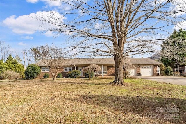 ranch-style home with a garage and a front lawn