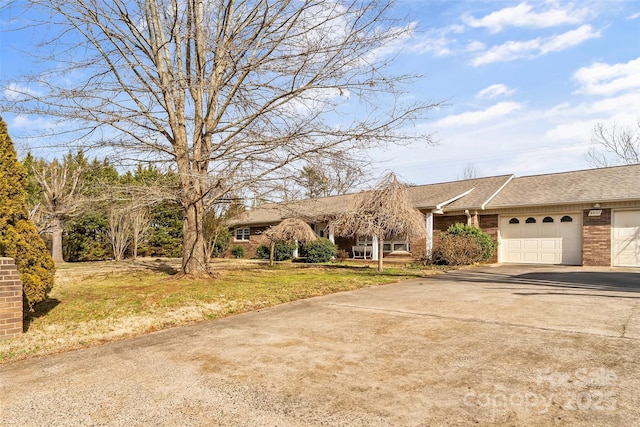 ranch-style house with a front yard and a garage