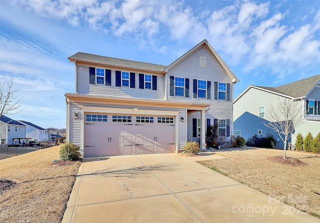 view of front of home featuring concrete driveway and an attached garage