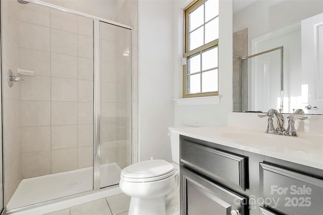 full bath with a stall shower, vanity, and toilet