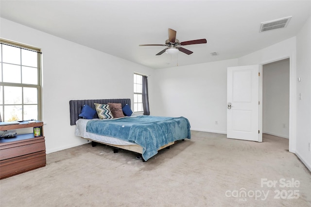 bedroom featuring light carpet, baseboards, visible vents, and a ceiling fan