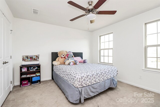 bedroom featuring light colored carpet, visible vents, and baseboards