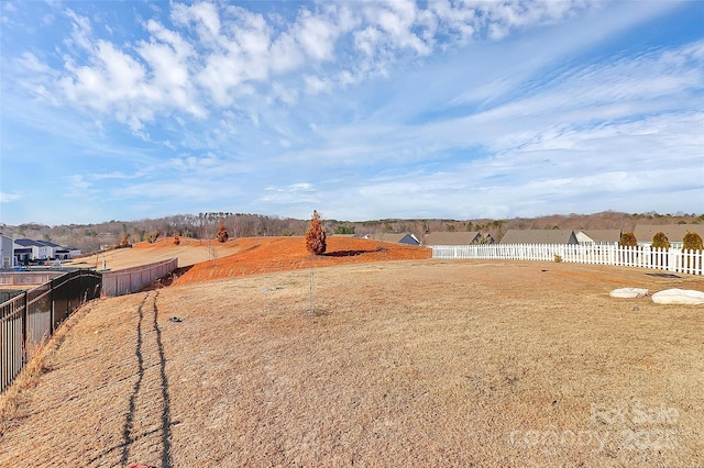 view of yard with a rural view and fence