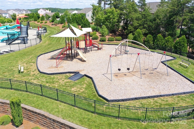 community playground with a lawn and fence