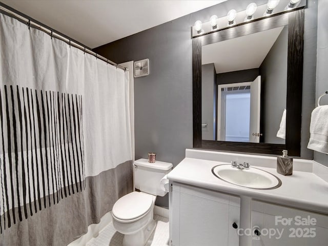 bathroom with toilet and vanity