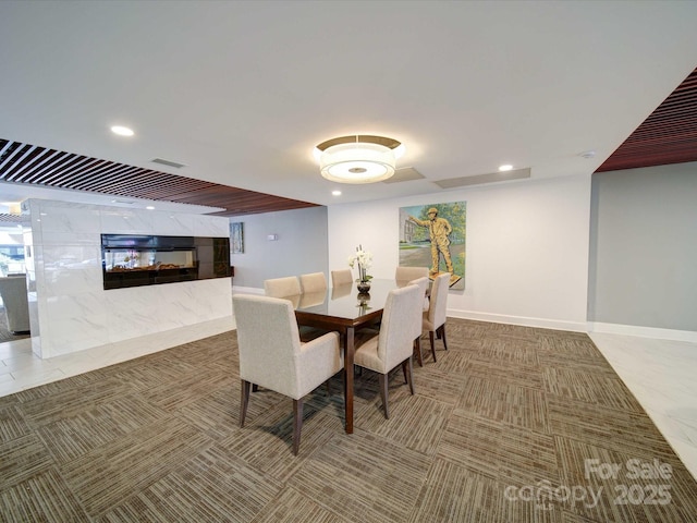 dining room with recessed lighting, visible vents, baseboards, and a fireplace