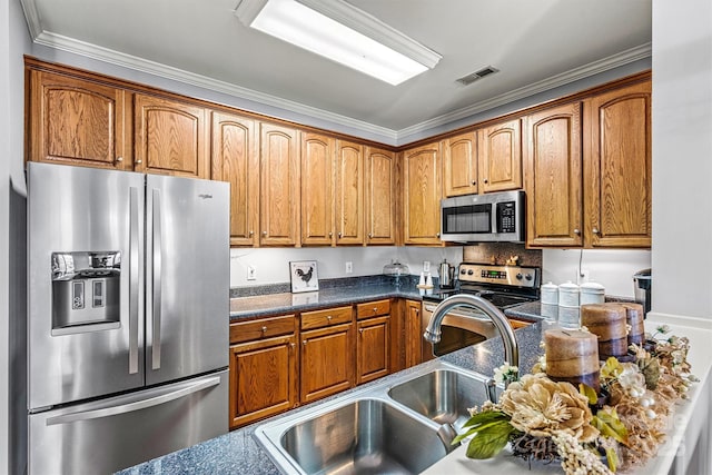 kitchen with brown cabinets, stainless steel appliances, visible vents, a sink, and dark stone counters