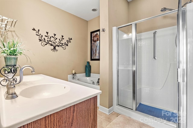 bathroom featuring a stall shower, double vanity, a bath, and tile patterned floors