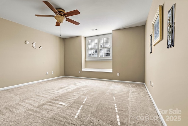 unfurnished room featuring baseboards, ceiling fan, visible vents, and light colored carpet