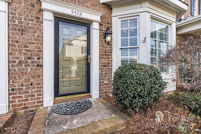 entrance to property with brick siding