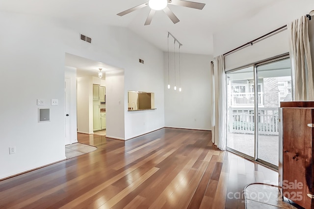 spare room featuring high vaulted ceiling, visible vents, ceiling fan, and wood finished floors