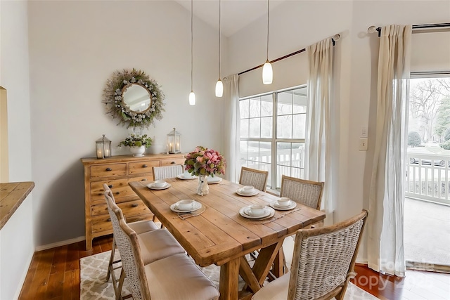 dining space with a healthy amount of sunlight, dark wood finished floors, and baseboards