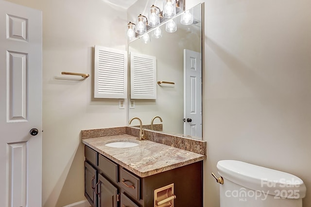 half bathroom with vanity and toilet