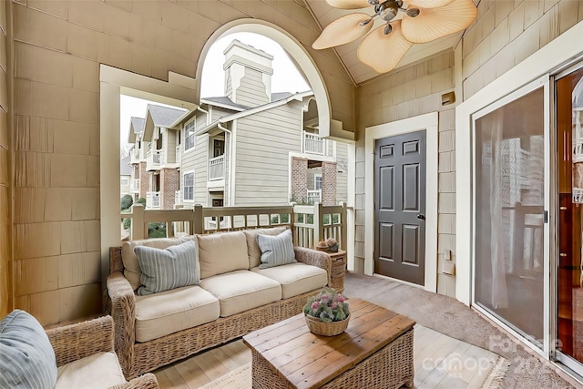 sunroom featuring lofted ceiling and ceiling fan