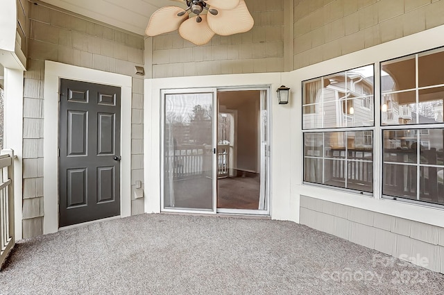 view of exterior entry featuring ceiling fan