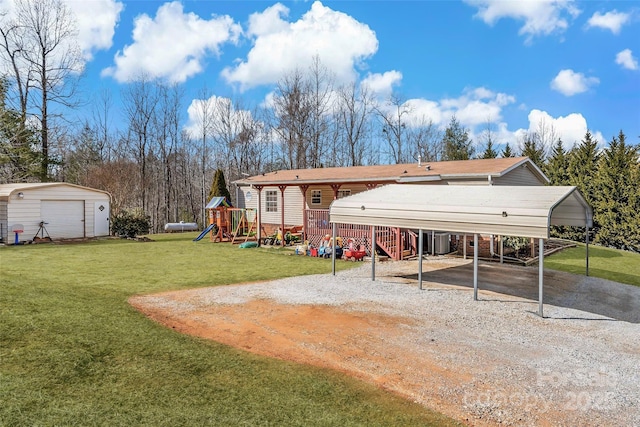 exterior space with a storage shed, a yard, a carport, and a playground