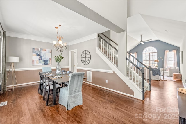 dining area with wood-type flooring, lofted ceiling, ceiling fan with notable chandelier, and crown molding