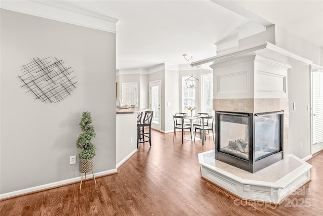 unfurnished living room featuring crown molding, hardwood / wood-style floors, and a fireplace