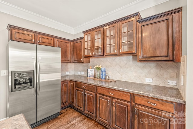 kitchen featuring stainless steel refrigerator with ice dispenser, ornamental molding, tasteful backsplash, and light hardwood / wood-style floors