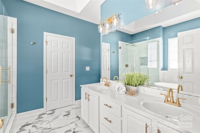 bathroom with a skylight, independent shower and bath, and vanity