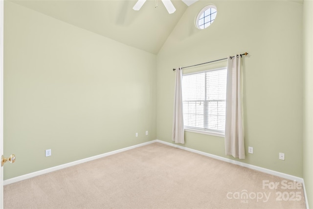 carpeted spare room with high vaulted ceiling and ceiling fan