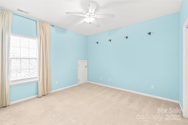 carpeted empty room featuring ceiling fan