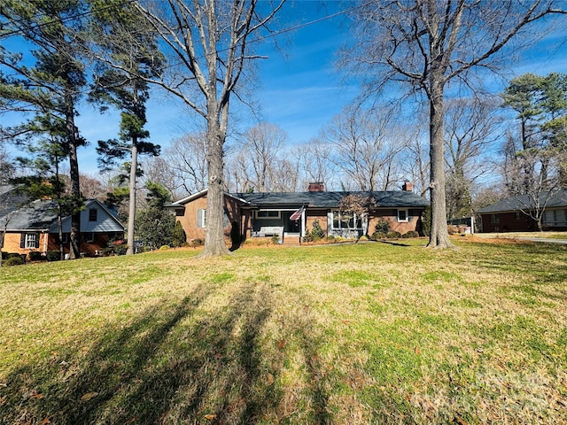 rear view of house featuring a yard