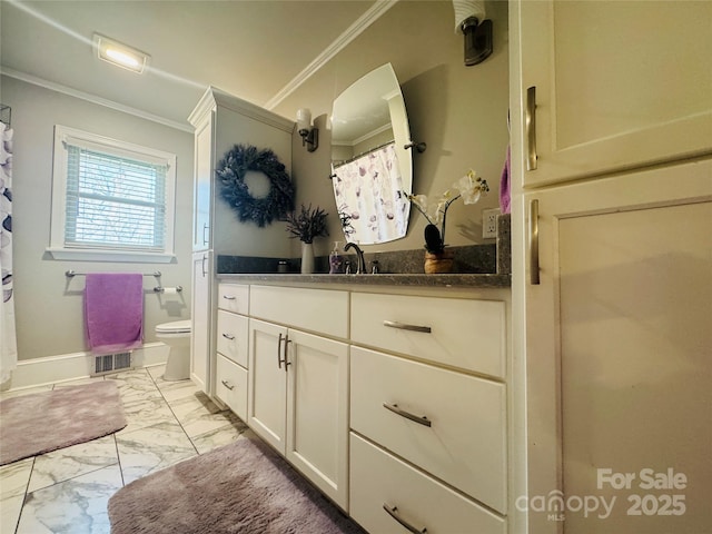 bathroom with crown molding, vanity, and toilet