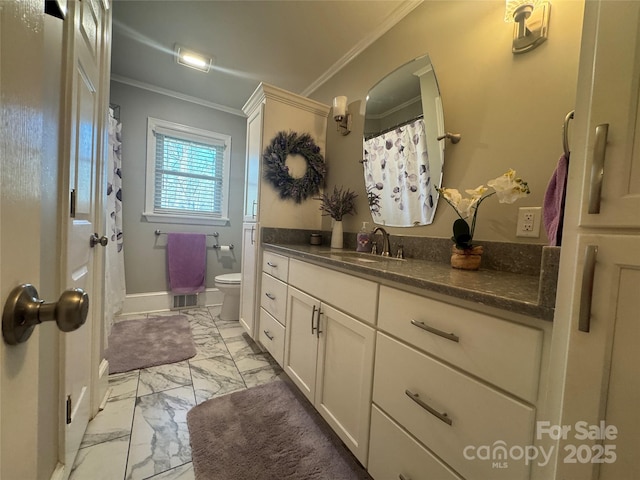 bathroom with vanity, ornamental molding, and toilet