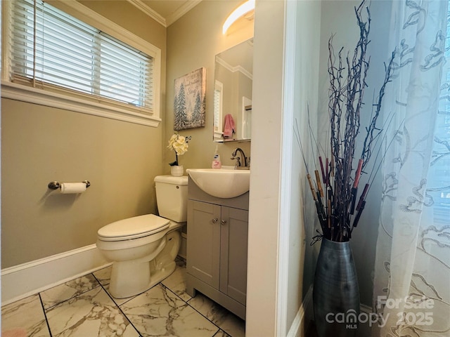 bathroom with ornamental molding, toilet, and vanity