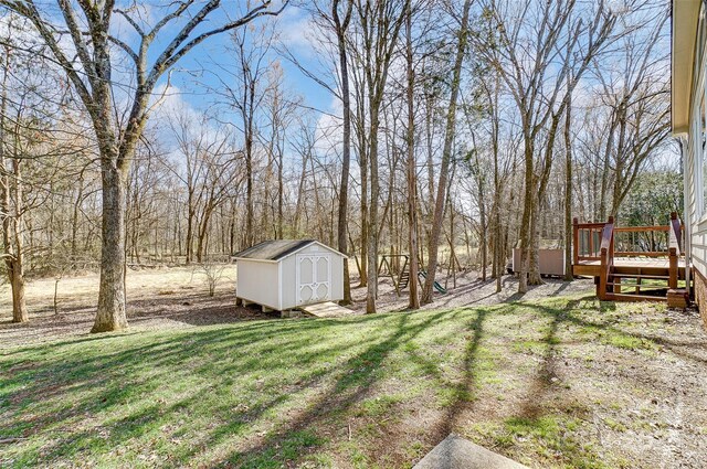 view of yard with a storage unit, a playground, and an outbuilding