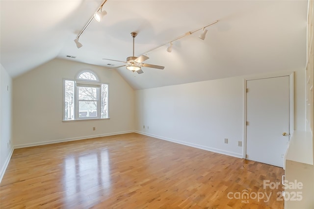 bonus room with baseboards, visible vents, a ceiling fan, lofted ceiling, and light wood-style flooring