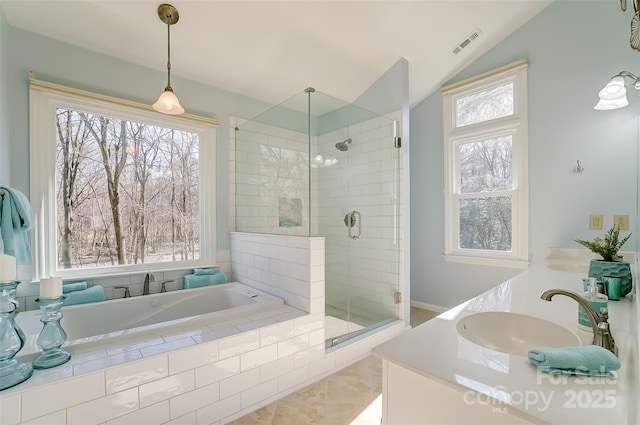 full bath with lofted ceiling, a garden tub, a sink, visible vents, and a shower stall