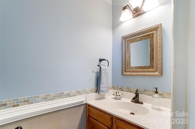 bathroom with tasteful backsplash and vanity