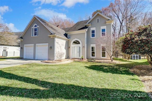 traditional-style house with a front lawn, driveway, a chimney, and an attached garage