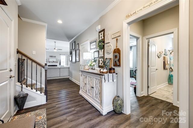 hall with stairway, crown molding, dark wood finished floors, baseboards, and recessed lighting