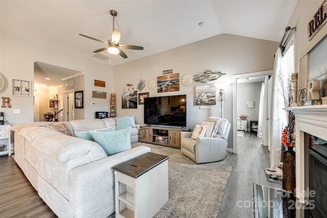 living room with vaulted ceiling, wood finished floors, and ceiling fan
