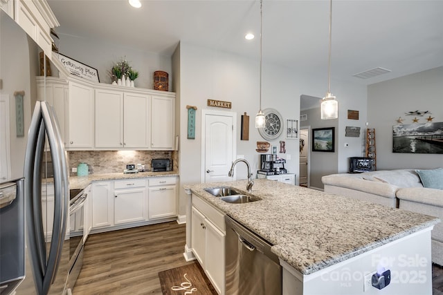 kitchen featuring a sink, open floor plan, visible vents, dark wood-type flooring, and appliances with stainless steel finishes