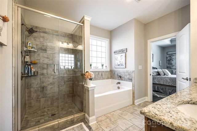 bathroom with a bath, baseboards, ensuite bathroom, and a stall shower