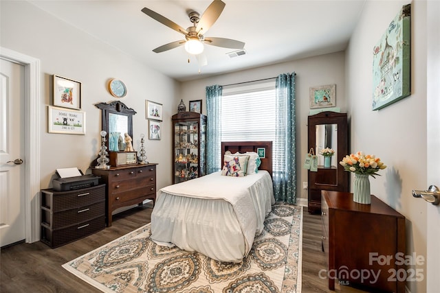 bedroom with a ceiling fan, dark wood-type flooring, and visible vents