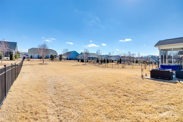 view of yard with a fenced backyard and a sunroom