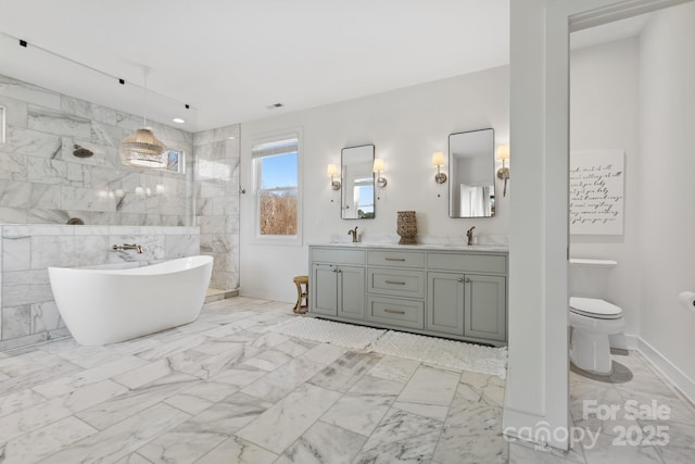 full bathroom with vanity, tile walls, toilet, and separate shower and tub