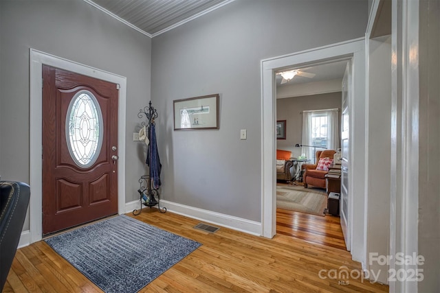 entrance foyer featuring light wood-type flooring and ornamental molding