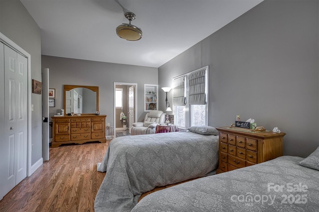 bedroom with hardwood / wood-style flooring and a closet