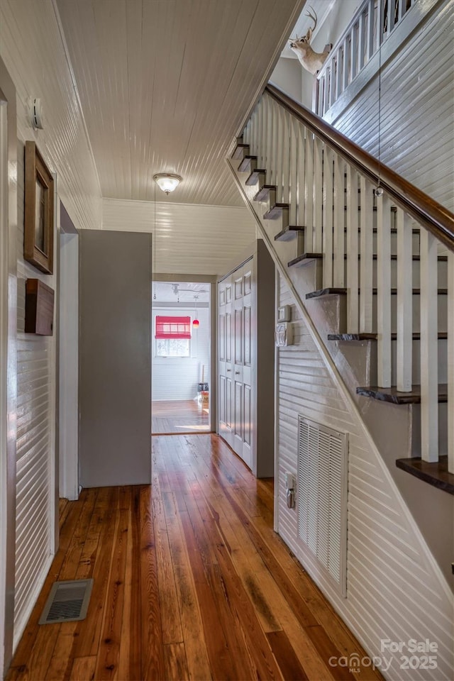 corridor with hardwood / wood-style floors