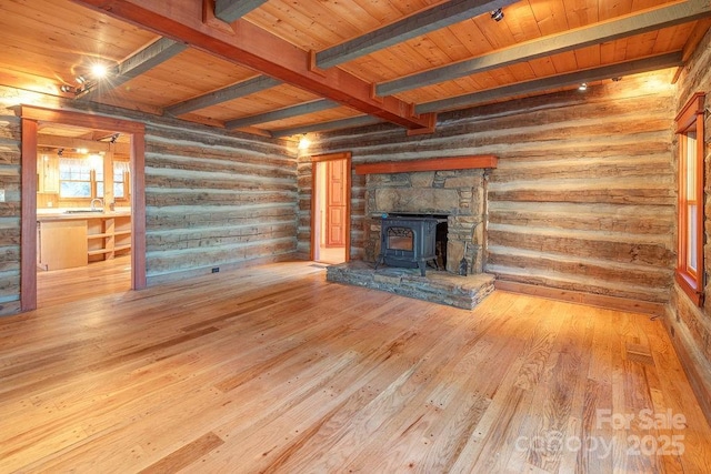 14 Woods Rd, Fairview, NC 28730 - unfurnished living room with a wood stove, hardwood / wood-style flooring, a wood ceiling with exposed beams, and rustic walls