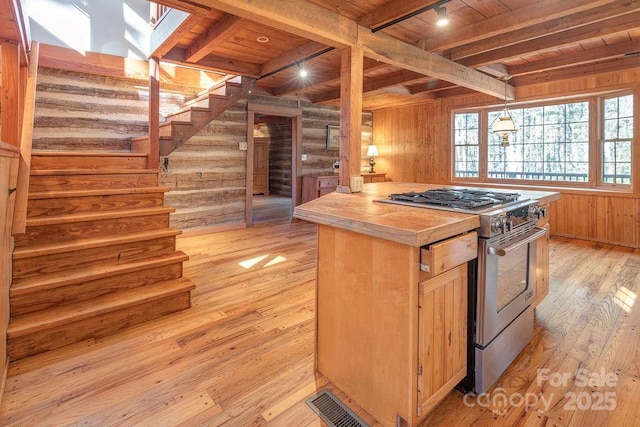 14 Woods Rd, Fairview, NC 28730 - kitchen with gas stove, a wood ceiling with exposed beams, light wood-style flooring, tile counters, and wood walls