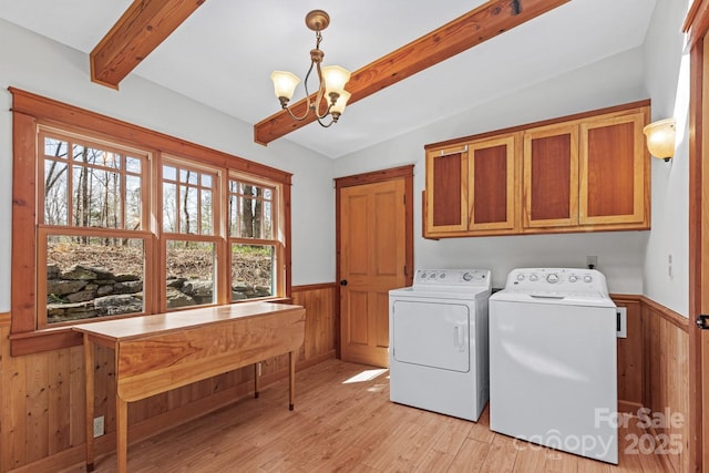 14 Woods Rd, Fairview, NC 28730 - washroom featuring cabinet space, wainscoting, washing machine and clothes dryer, a chandelier, and wood walls