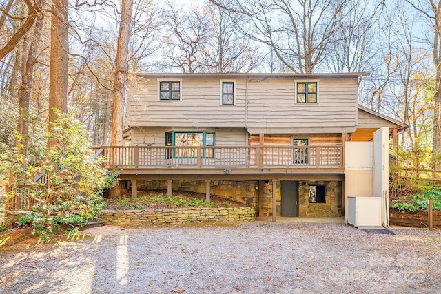 14 Woods Rd, Fairview, NC 28730 - view of front facade featuring a deck, stone siding, and a carport