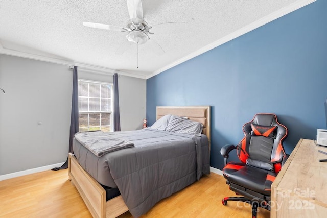 bedroom with ornamental molding, a textured ceiling, ceiling fan, and hardwood / wood-style flooring